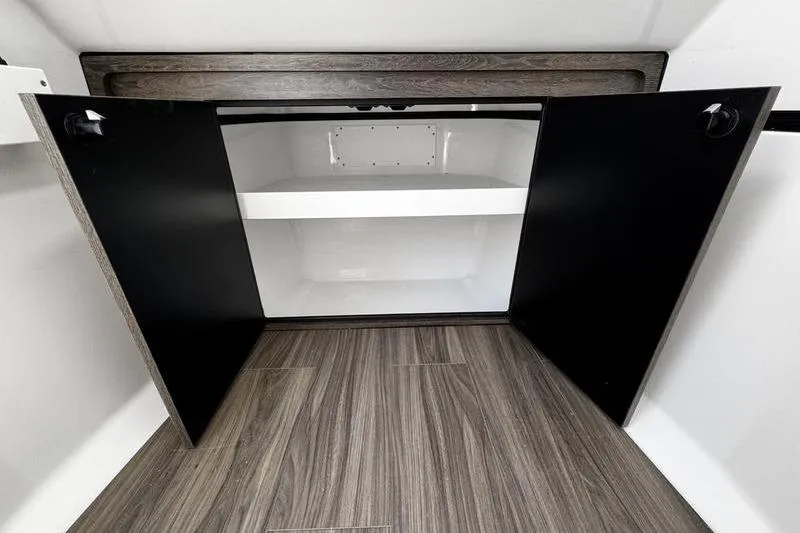 Slide: The Image of 2026 Sportsman Heritage 321 Center Console interior with beige seating and storage compartments. - 31