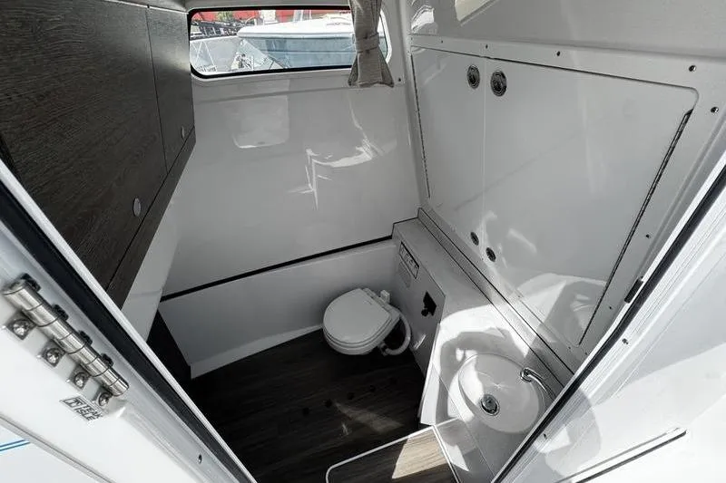 Slide: The Image of 2026 Sportsman Heritage 321 Center Console boat interior with open storage compartment. - 33