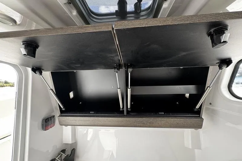 Slide: The Image of 2026 Sportsman Heritage 321 Center Console boat with beige cushioned seating and dual engines. - 35