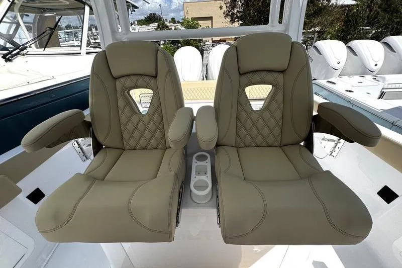 Slide: The Image of 2026 Sportsman Heritage 321 Center Console with beige seating and multiple outboard engines. - 36