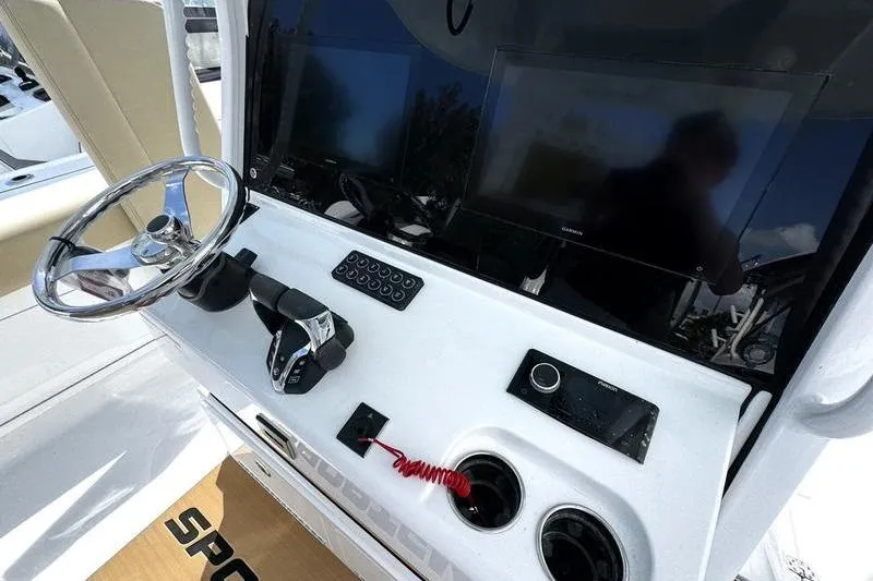 Slide: The Image of 2026 Sportsman Heritage 321 Center Console interior with beige seating and storage compartments. - 37