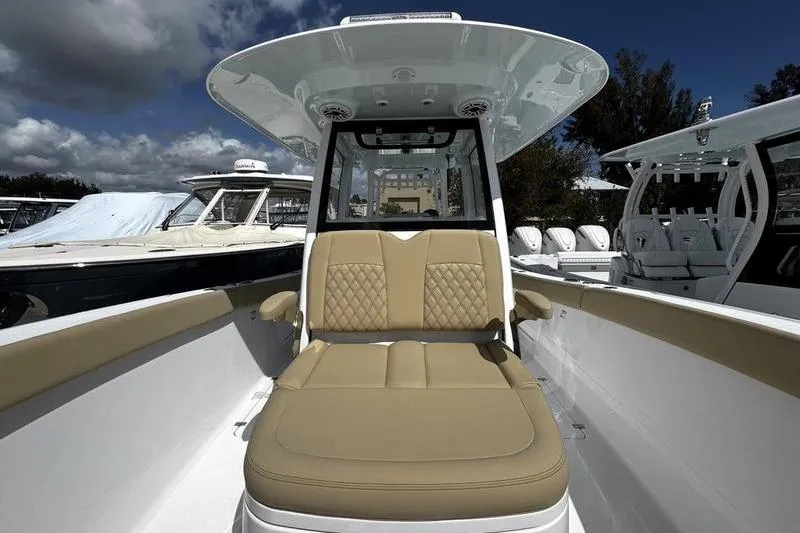 Slide: The Image of 2026 Sportsman Heritage 321 Center Console boat with tan seating and white deck. - 8