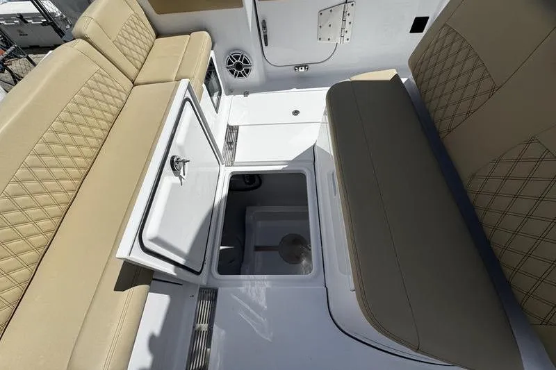 Slide: The Image of 2026 Sportsman Heritage 321 Center Console boat with tan seating, docked among other boats. - 9