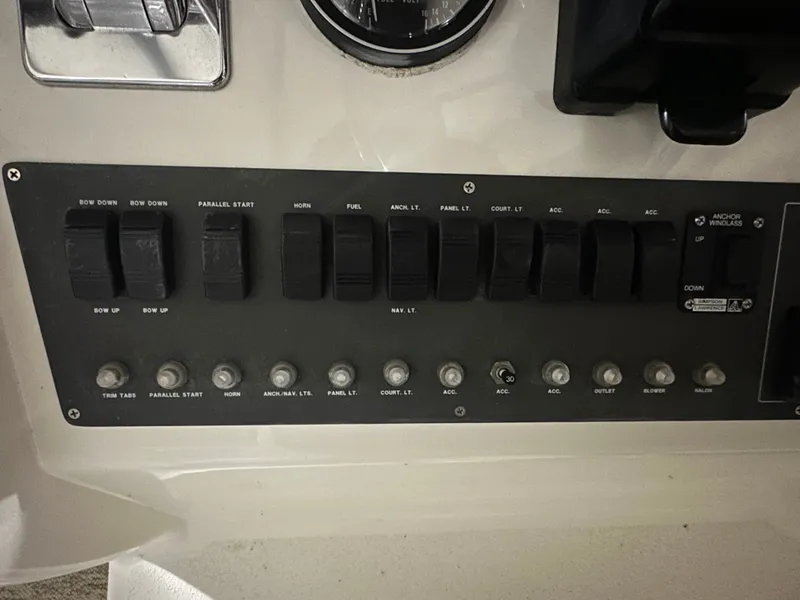 Slide: The Image of 1998 Silverton 351 Sedan dashboard with switches and gauges. - 14