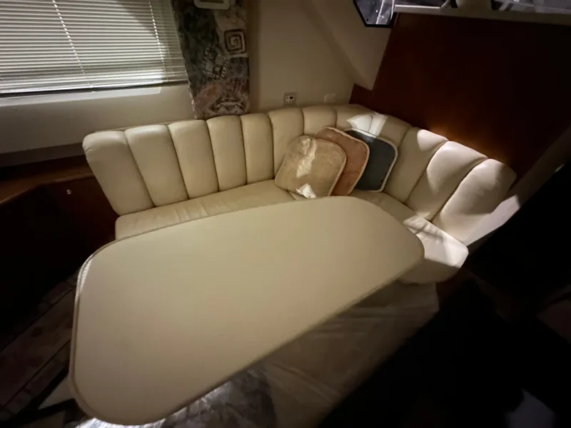 Slide: The Image of Interior of a 1998 Silverton 351 Sedan with beige sofa and table. - 20