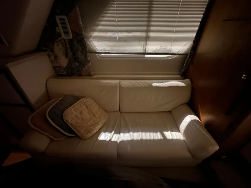 Slide: The Image of Interior of a 1998 Silverton 351 Sedan with beige sofa and cushions. - 22