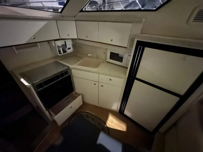 Slide: The Image of Interior of 1998 Silverton 351 Sedan with kitchen and appliances. - 24