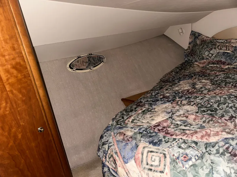 Slide: The Image of Interior of a 1998 Silverton 351 Sedan yacht with bed and porthole. - 27