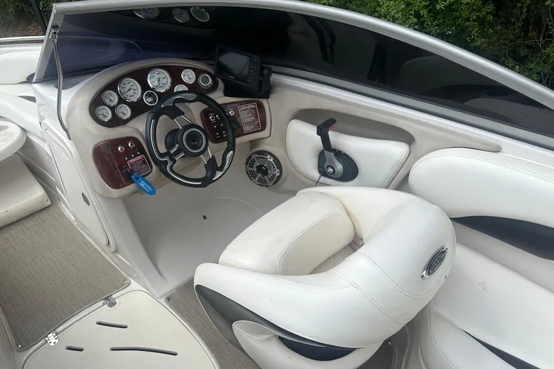 Slide: The Image of Interior of a 2006 Tahoe Q8i boat featuring steering wheel and dashboard controls. - 5