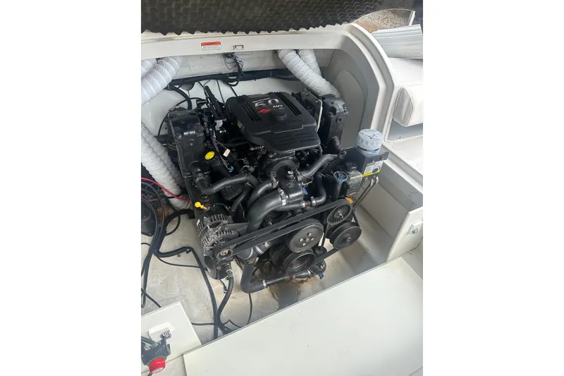 Slide: The Image of Engine compartment of a 2006 Tahoe Q8i boat, showcasing mechanical components and wiring. - 8