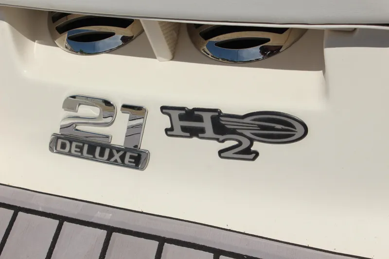 Slide: The Image of 2016 Chaparral 21 H2O Sport boat emblem on white surface. - 10