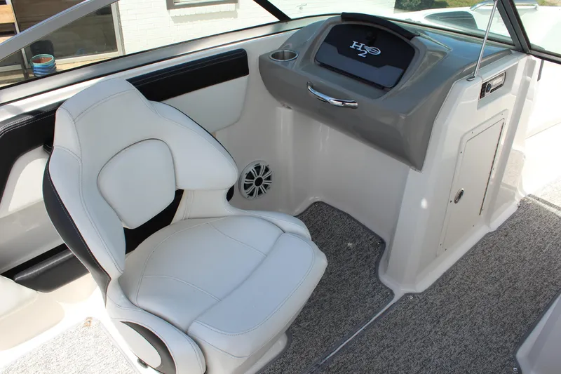 Slide: The Image of 2016 Chaparral 21 H2O Sport boat interior with white seating and dashboard. - 12