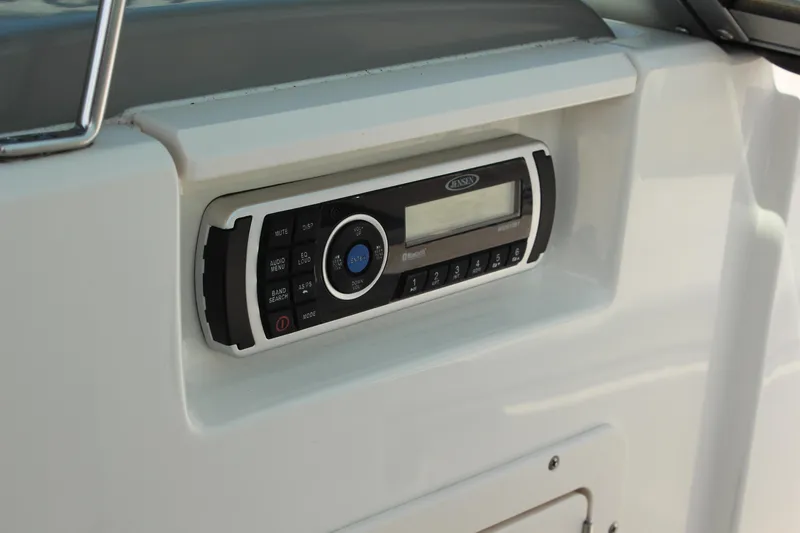Slide: The Image of 2016 Chaparral 21 H2O Sport boat stereo system, featuring Jensen audio controls. - 13