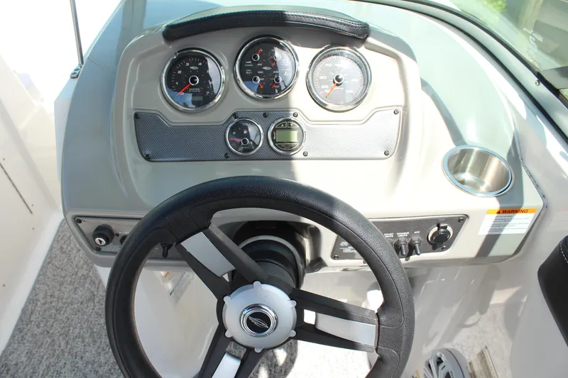 Slide: The Image of Dashboard of a 2016 Chaparral 21 H2O Sport boat with steering wheel and gauges. - 14