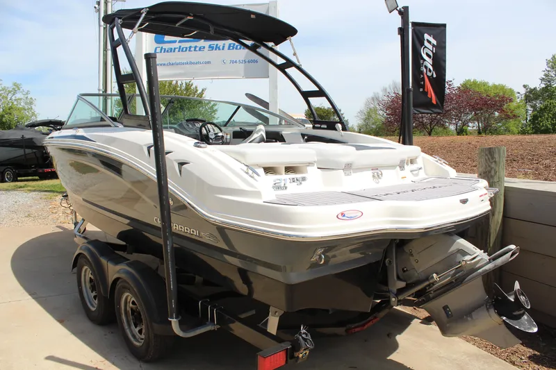 Slide: The Image of 2016 Chaparral 21 H2O Sport boat on trailer, displayed outdoors at dealership. - 4