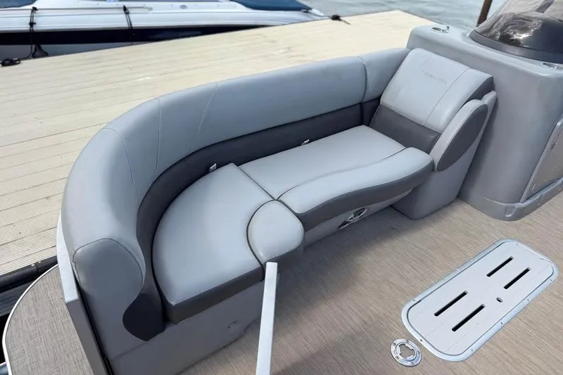 Slide: The Image of 2018 Veranda VR25RC boat interior with gray seating and wooden deck. - 12