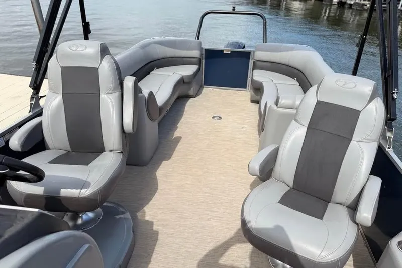 Slide: The Image of 2018 Veranda VR25RC pontoon boat interior with gray seating and water view. - 13