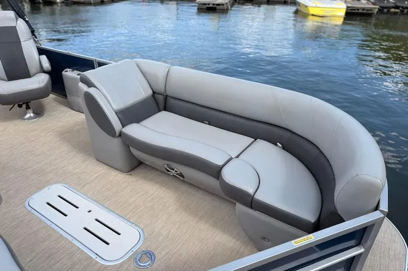 Slide: The Image of 2018 Veranda VR25RC pontoon boat with gray seating, docked by the water. - 5