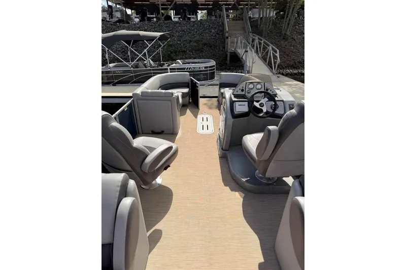 Slide: The Image of 2018 Veranda VR25RC pontoon boat interior with steering console and seating. - 8
