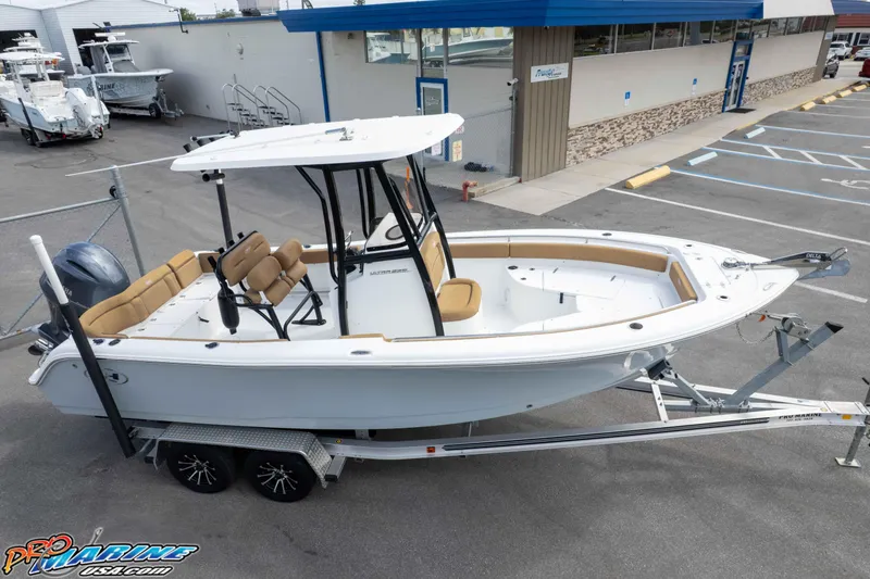 Slide: The Image of 2023 Sea Hunt Ultra 229 boat on trailer at dealership parking lot. - 11