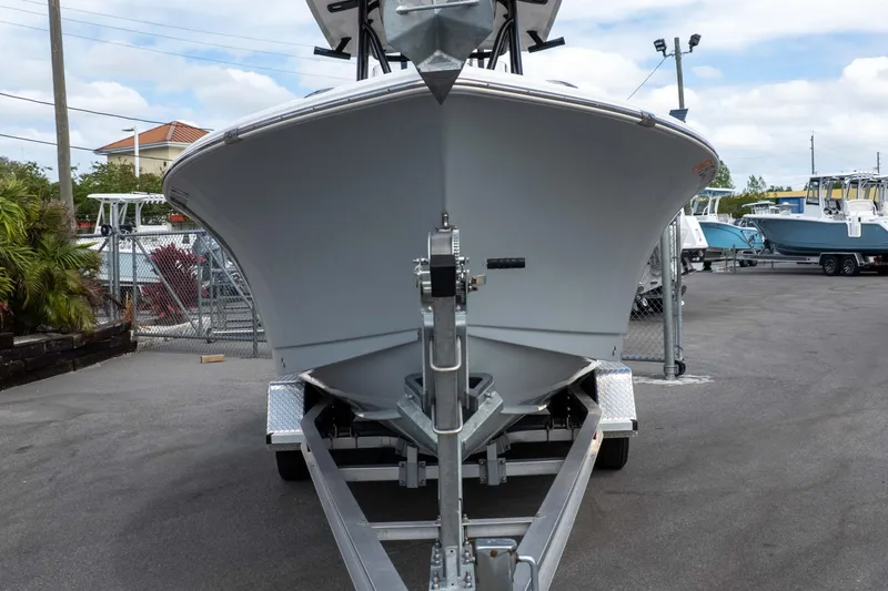 Slide: The Image of 2023 Sea Hunt Ultra 229 boat on trailer in a marina setting. - 13