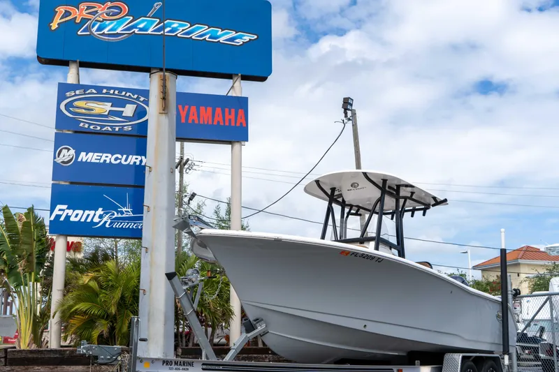 Slide: The Image of 2023 Sea Hunt Ultra 229 boat displayed at Pro Marine dealership with brand signage. - 2