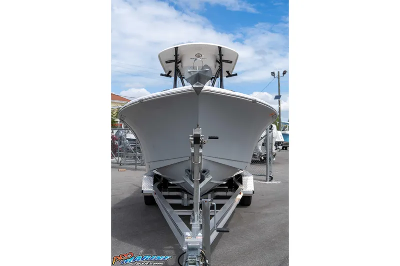 Slide: The Image of 2023 Sea Hunt Ultra 229 boat on trailer, displayed outdoors under a clear sky. - 23
