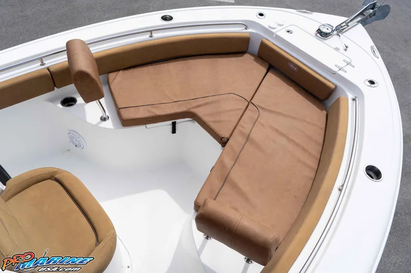 Slide: The Image of 2023 Sea Hunt Ultra 229 boat interior with tan cushioned seating and sleek design. - 30