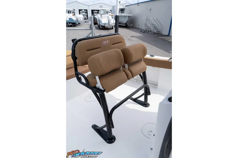 Slide: The Image of Brown cushioned seating on 2023 Sea Hunt Ultra 229 boat, docked at a marina. - 32