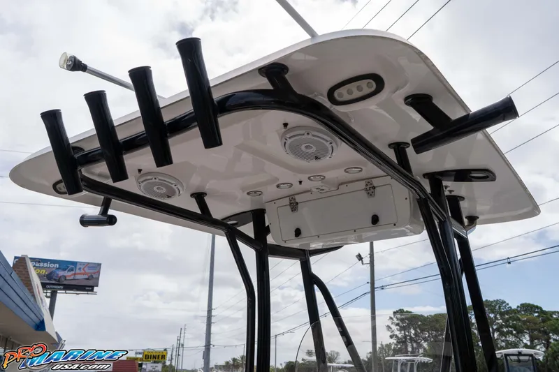 Slide: The Image of 2023 Sea Hunt Ultra 229 T-top with rod holders and speakers, viewed from below. - 34