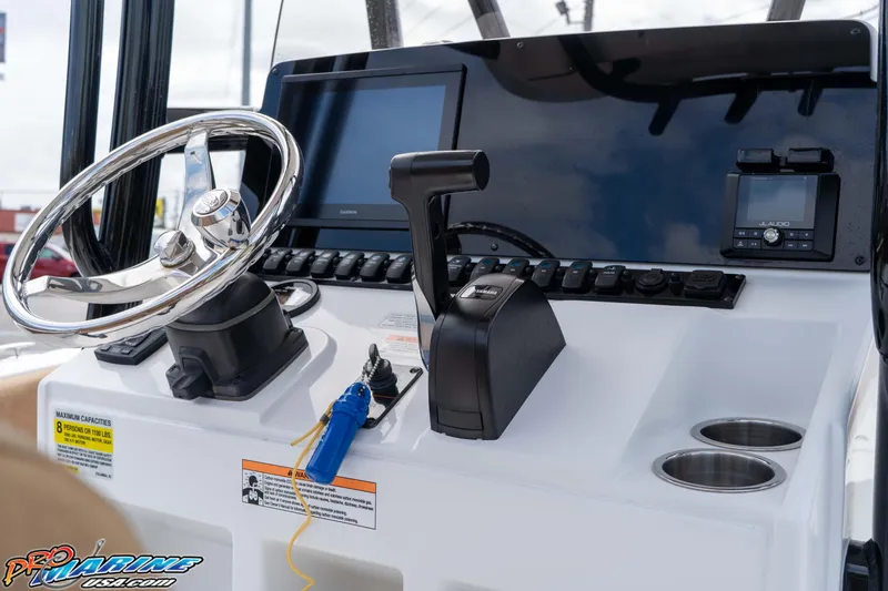 Slide: The Image of 2023 Sea Hunt Ultra 229 boat dashboard with steering wheel and controls. - 35