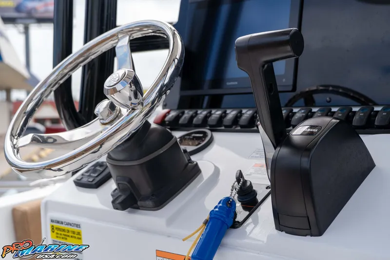 Slide: The Image of 2023 Sea Hunt Ultra 229 boat dashboard with steering wheel and throttle controls. - 36