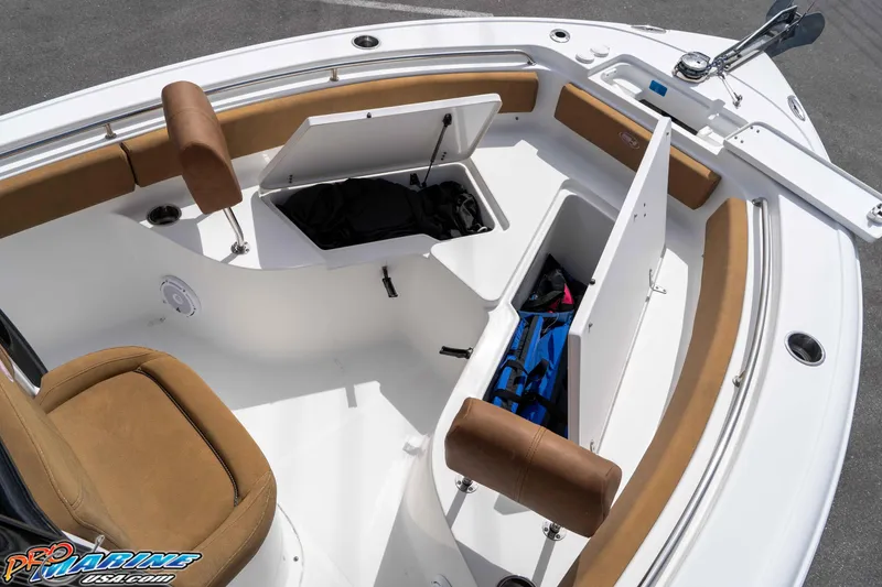 Slide: The Image of 2023 Sea Hunt Ultra 229 boat interior with open storage compartments and cushioned seating. - 38