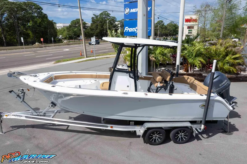 Slide: The Image of 2023 Sea Hunt Ultra 229 boat on trailer, parked outdoors near dealership. - 4