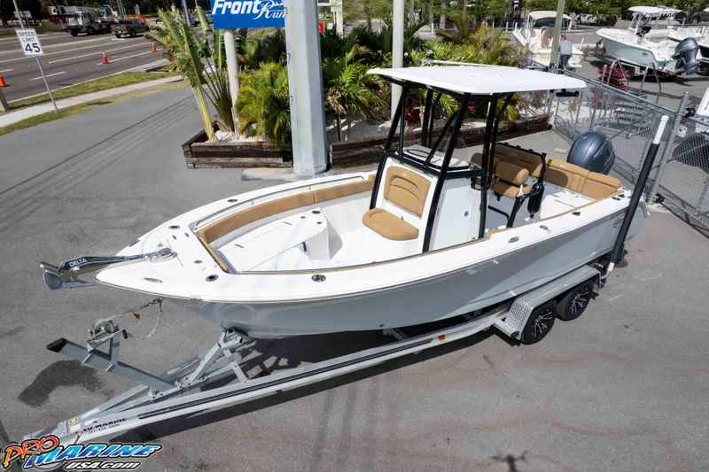 Slide: The Image of 2023 Sea Hunt Ultra 229 boat on trailer, parked outdoors near dealership. - 40