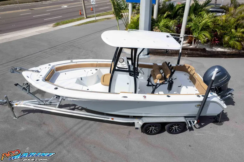 Slide: The Image of 2023 Sea Hunt Ultra 229 boat on trailer, featuring Yamaha engine, parked near road. - 41