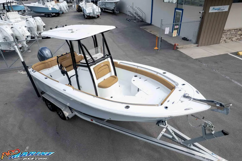 Slide: The Image of 2023 Sea Hunt Ultra 229 boat on trailer at dealership, showcasing sleek design and spacious interior. - 44