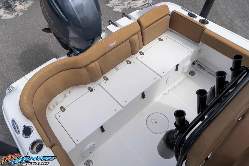 Slide: The Image of 2023 Sea Hunt Ultra 229 boat interior with tan seating and storage compartments. - 49