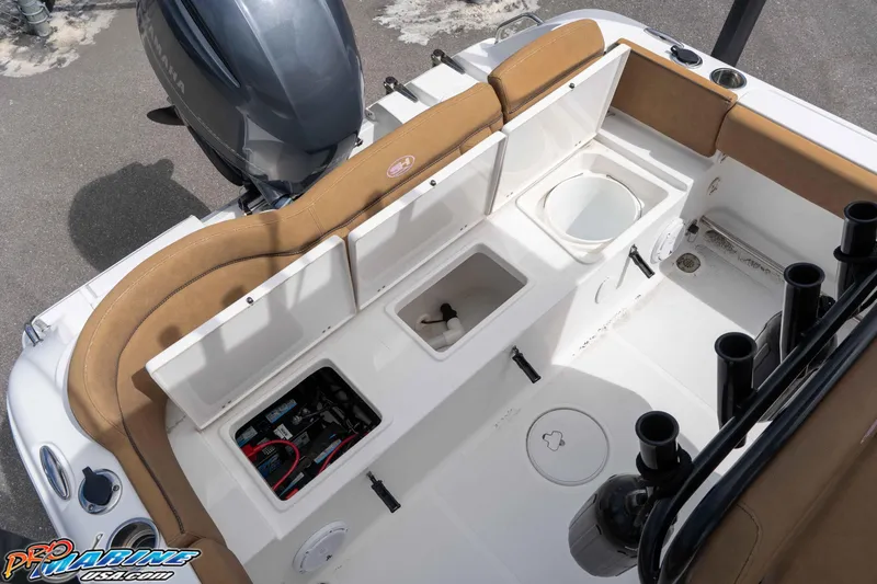 Slide: The Image of 2023 Sea Hunt Ultra 229 boat interior with storage compartments and seating. - 50