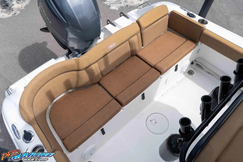 Slide: The Image of 2023 Sea Hunt Ultra 229 boat interior with brown cushioned seating and Yamaha engine. - 51