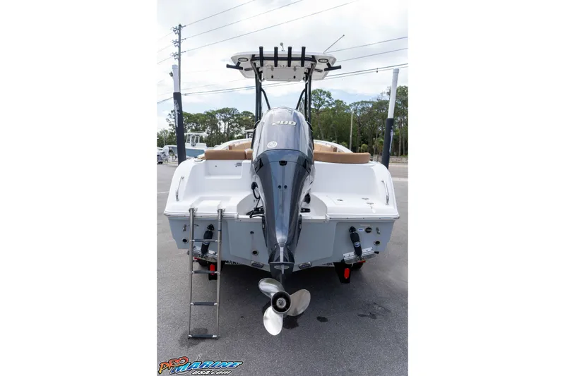 Slide: The Image of 2023 Sea Hunt Ultra 229 boat rear view with outboard motor and ladder. - 6