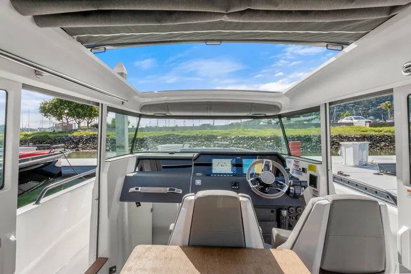Slide: The Image of Interior view of 2021 Axopar 37 XC Cross Cabin boat with modern dashboard and seating. - 10
