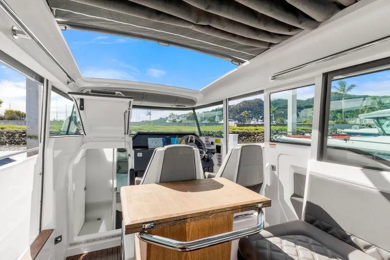 Slide: The Image of Interior of 2021 Axopar 37 XC Cross Cabin with seating and helm view. - 11