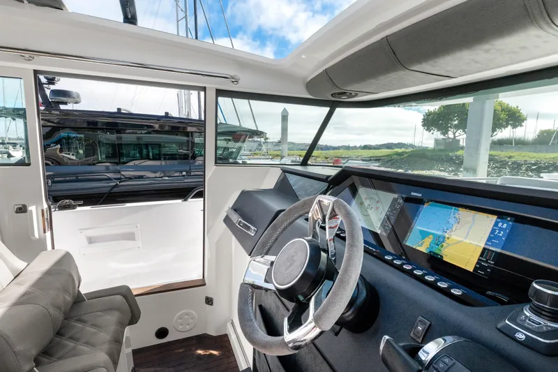 Slide: The Image of Interior view of 2021 Axopar 37 XC Cross Cabin with modern navigation system. - 13