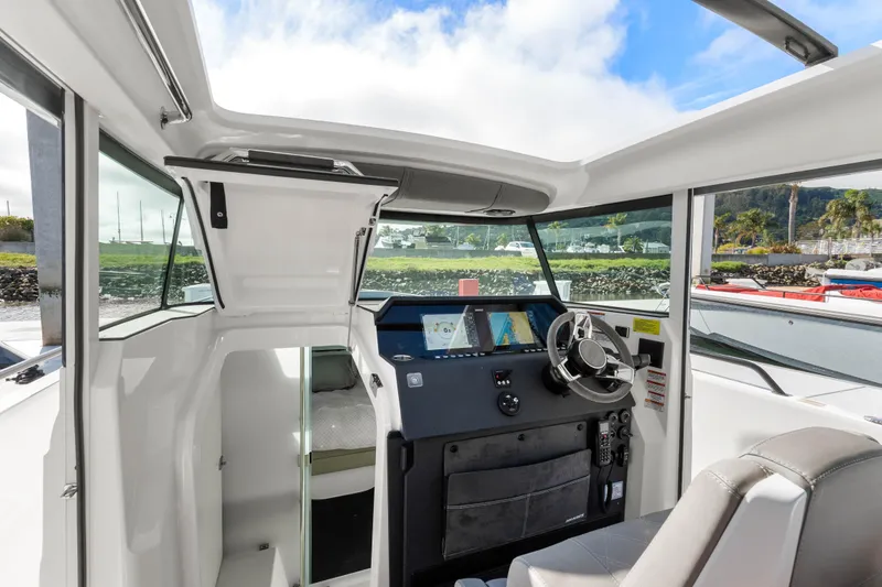 Slide: The Image of 2021 Axopar 37 XC Cross Cabin interior with modern helm and navigation system. - 16