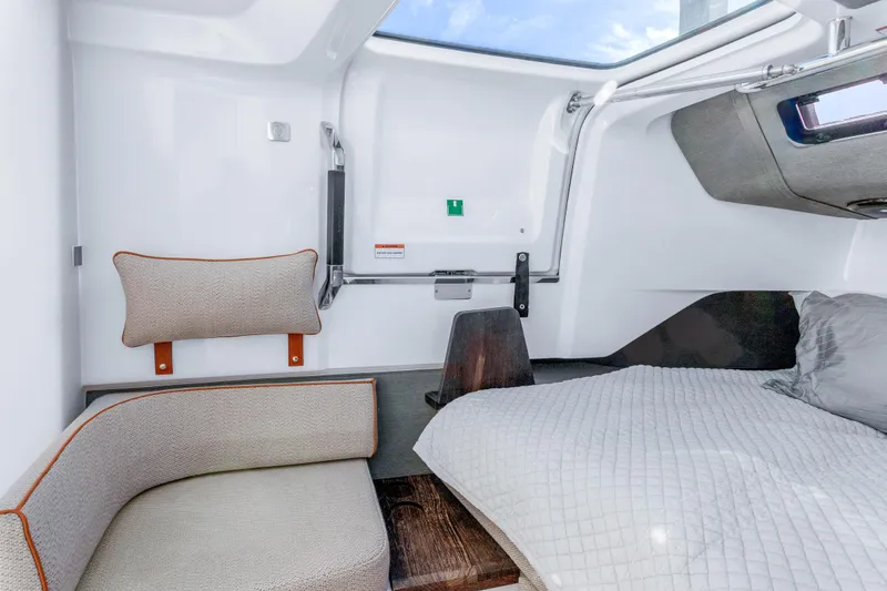 Slide: The Image of Interior of 2021 Axopar 37 XC Cross Cabin, featuring cozy seating and bedding. - 22