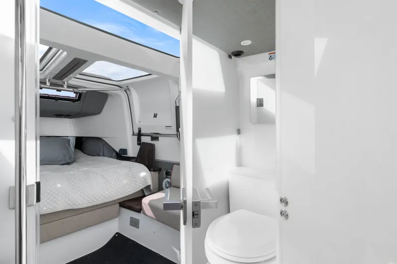Slide: The Image of Interior of 2021 Axopar 37 XC Cross Cabin with bed and compact bathroom. - 26