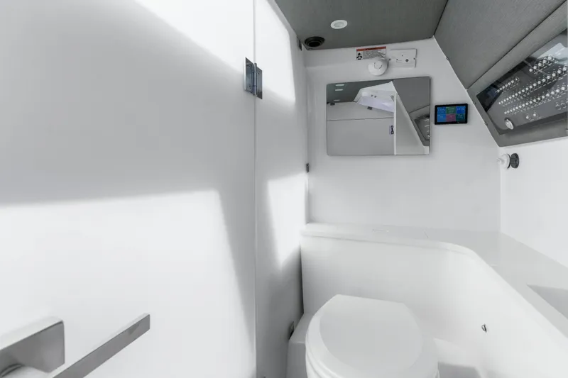 Slide: The Image of 2021 Axopar 37 XC Cross Cabin bathroom interior with modern fixtures and mirror. - 28