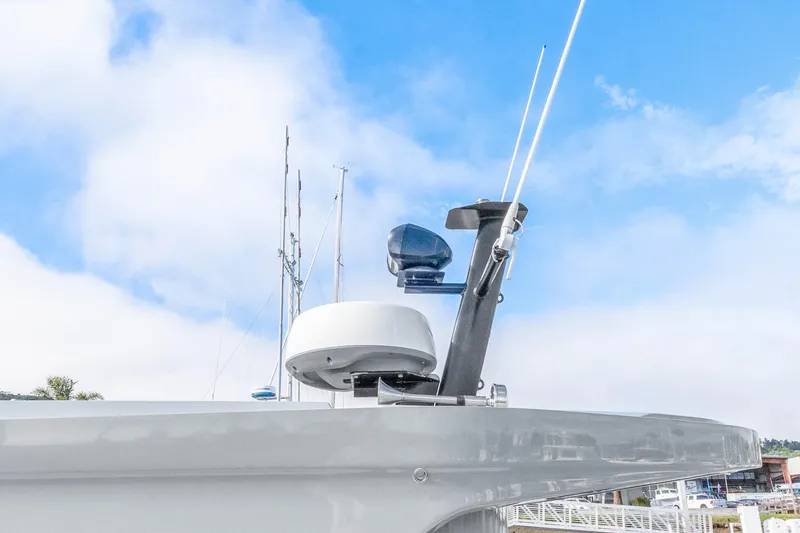 Slide: The Image of Radar and antennas on 2021 Axopar 37 XC Cross Cabin against blue sky. - 31