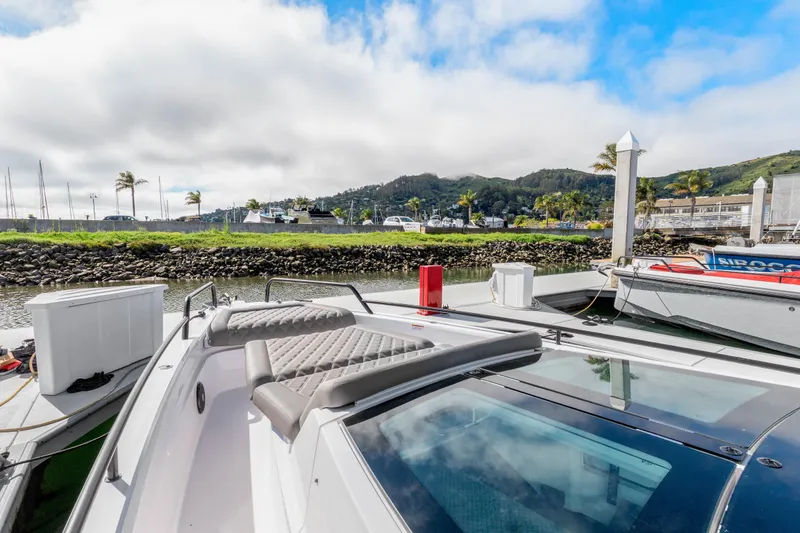 Slide: The Image of 2021 Axopar 37 XC Cross Cabin docked with scenic marina backdrop. - 33